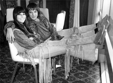 Sonny and Cher reclining on chairs looking happy and in love