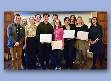 A large group of award winners and others celebrating.