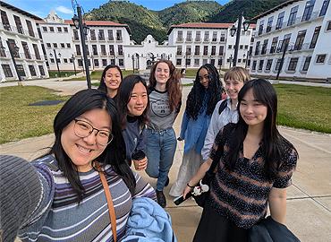 A group of students pose for a selfie.