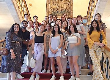 a group of students posing on a elegant staircase