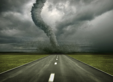 road with tornado in distance