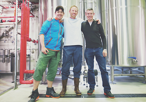 Paul Speed, Chris Hainge and Benjamin Falck standing in a brewery.