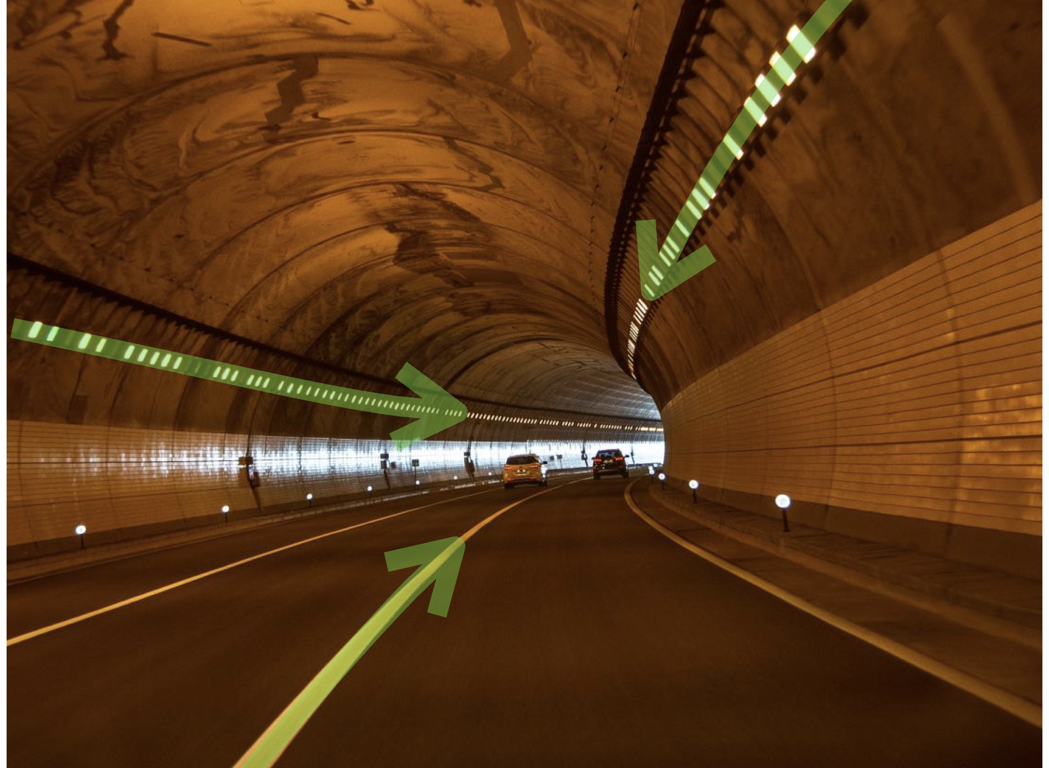 A curving road tunnel with lines