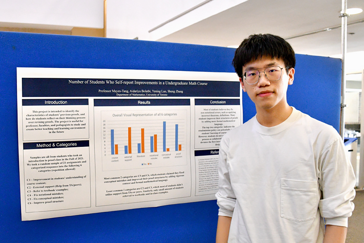  Sheng Zhang standing in front of his poster