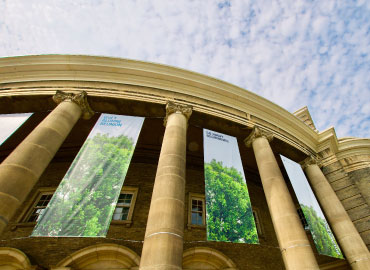 Convocation Hall with large banners on a sunny day.