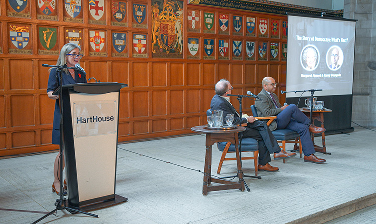 Dean Melanie Woodin at a podium on stage