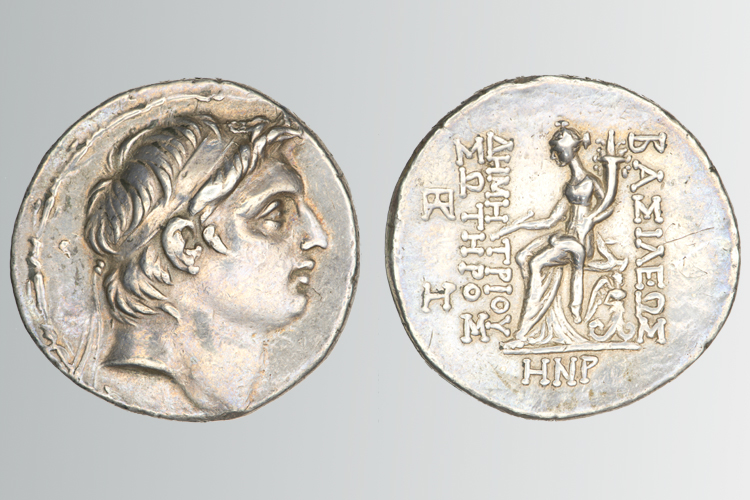 Two coins, the coin on the left is a profile of a face, the other on the right is a full profile of a women with letters and text.